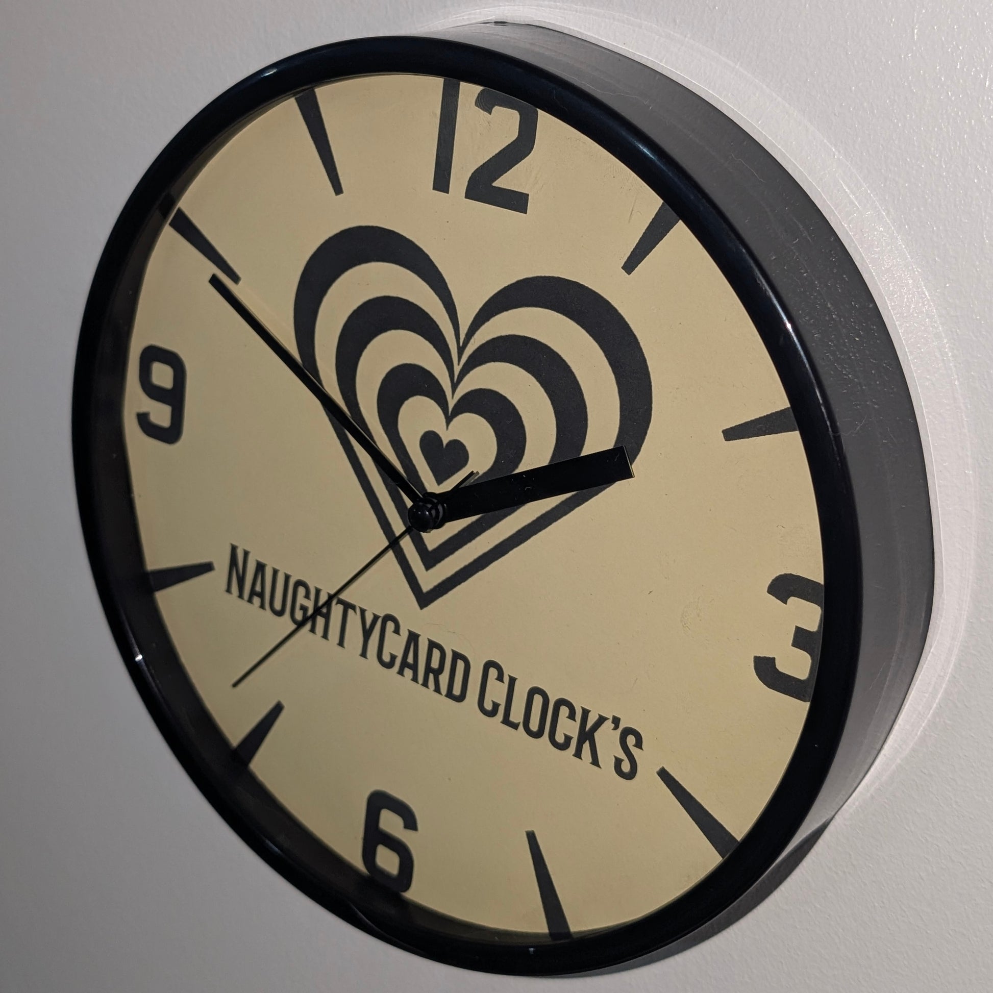 Top view of value black wall clock on plain white background