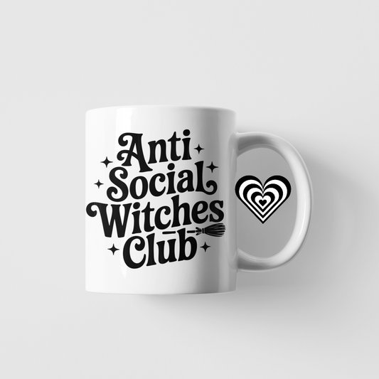 White mug with 'Anti Social Witches Club' text on a light gray background