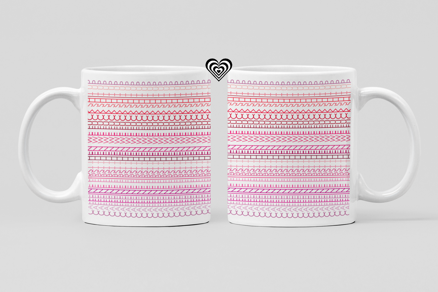 Two white mugs with pink patterned designs on a light gray background