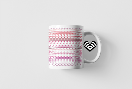 White mug with pink pattern and black heart design on a white background