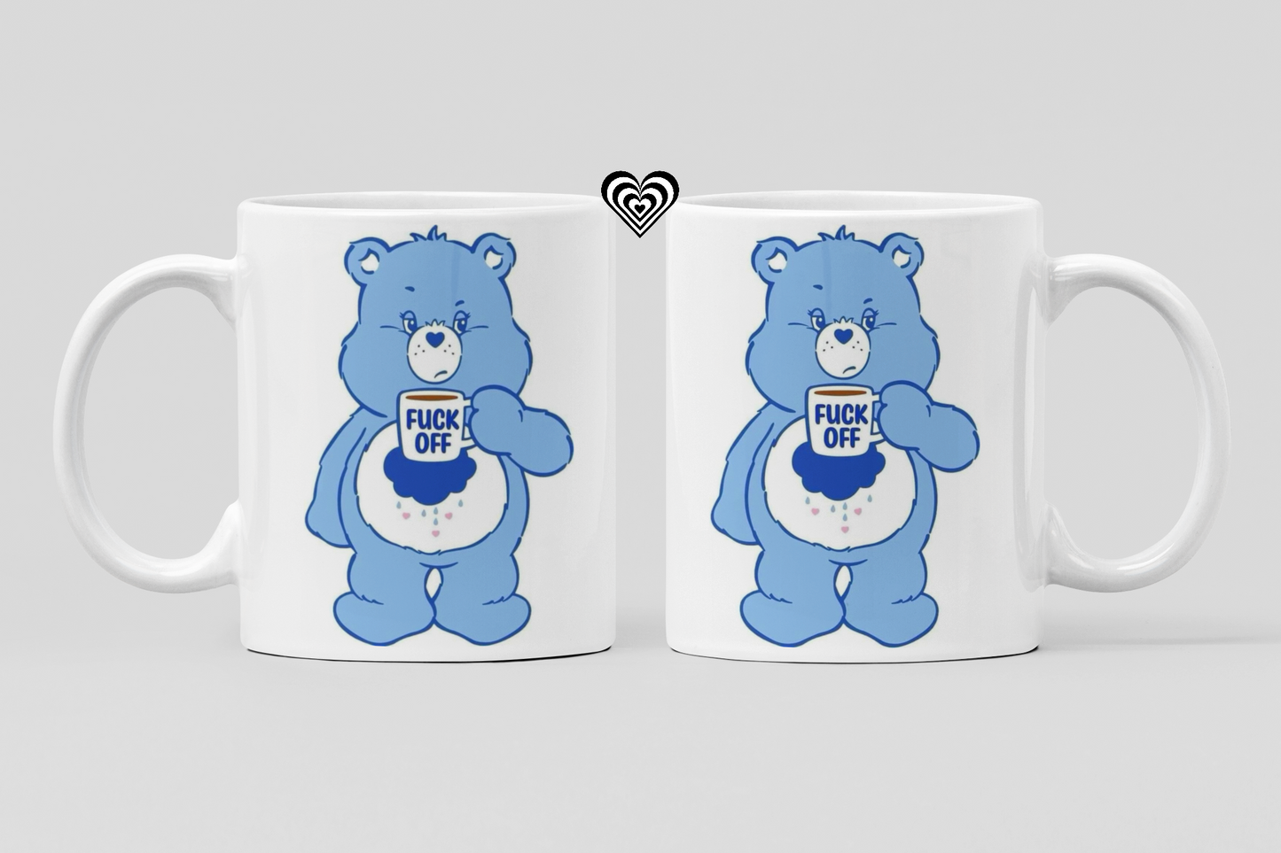 Two white mugs with blue cartoon bear designs and profane text on a light gray background.