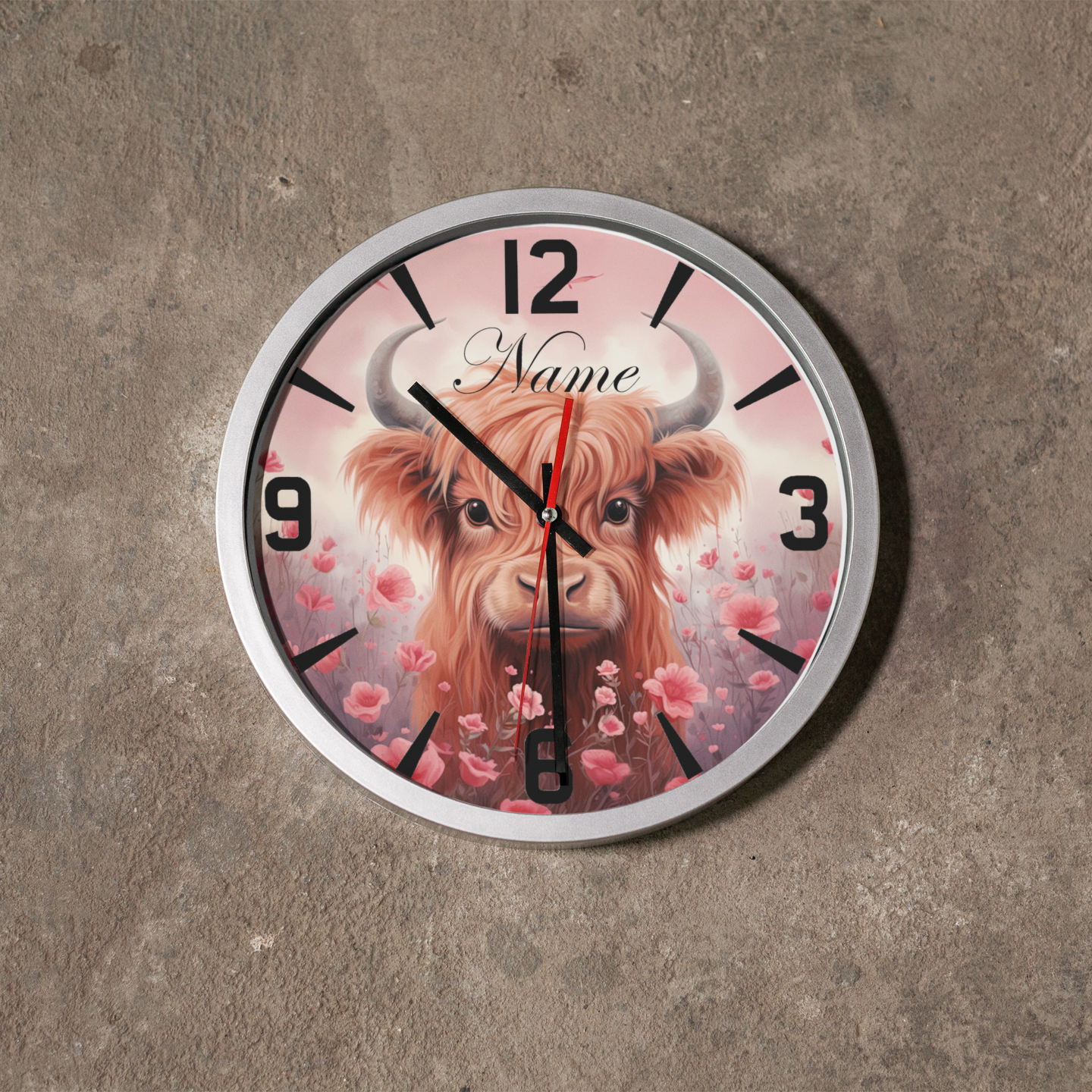 A silver metallic wall clock featuring an image of Highland Cow and numbers, predominantly in black and Pink with a silver or metallic accent. Metallic Wall Clock from NaughtyCard