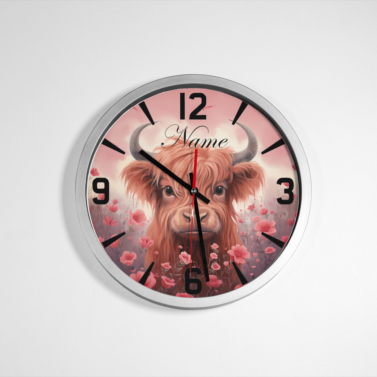 A silver metallic wall clock featuring an image of Highland Cow and numbers, predominantly in black and Pink with a silver or metallic accent. Metallic Wall Clock from NaughtyCard