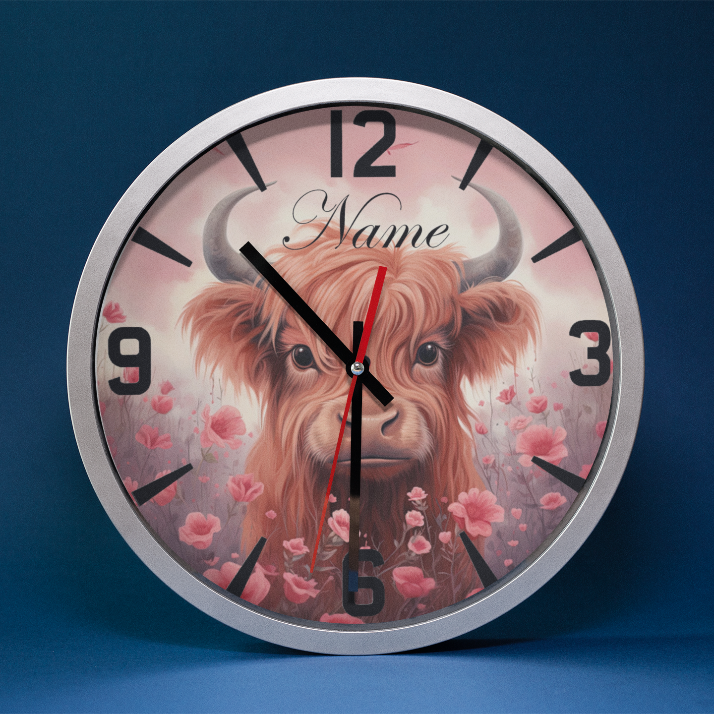 A silver metallic wall clock featuring an image of Highland Cow and numbers, predominantly in black and Pink with a silver or metallic accent. Metallic Wall Clock from NaughtyCard