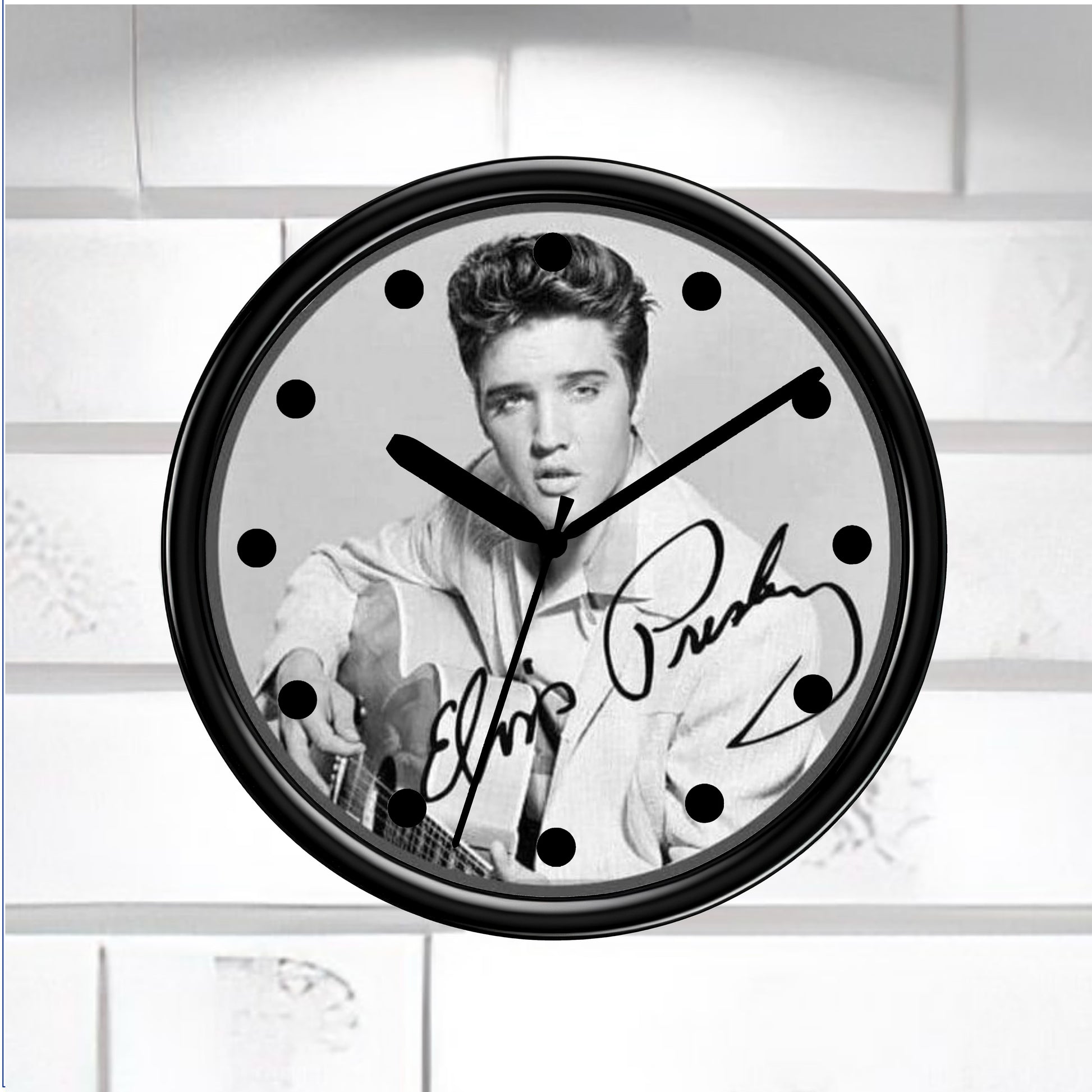 Wall clock with a black and white portrait of a famous person and signature on a light background