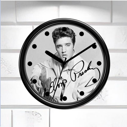 Wall clock with a black and white portrait of a famous person and signature on a light background