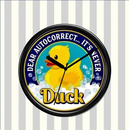 Round clock with a yellow duck illustration and humorous text on a striped background
