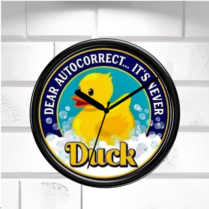 Wall clock with a rubber duck design and humorous text on a white background