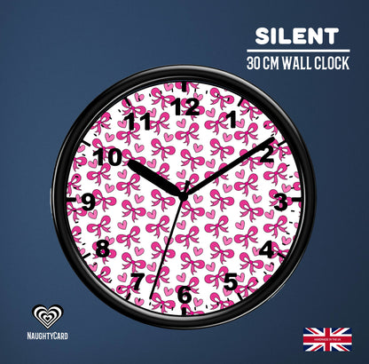 Wall clock with pink bow and heart pattern on a blue background