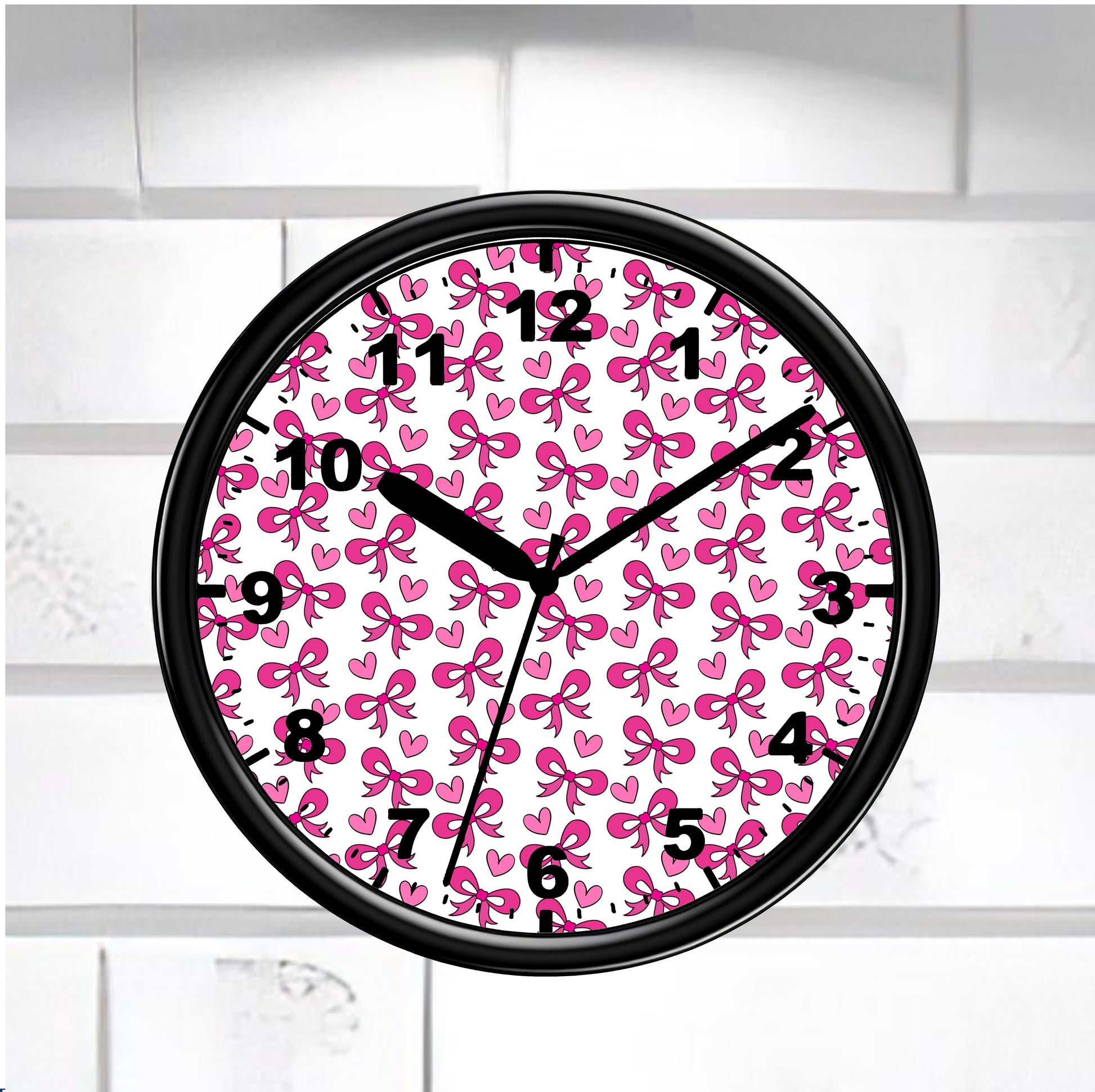 Wall clock with pink bow pattern on a white brick wall background