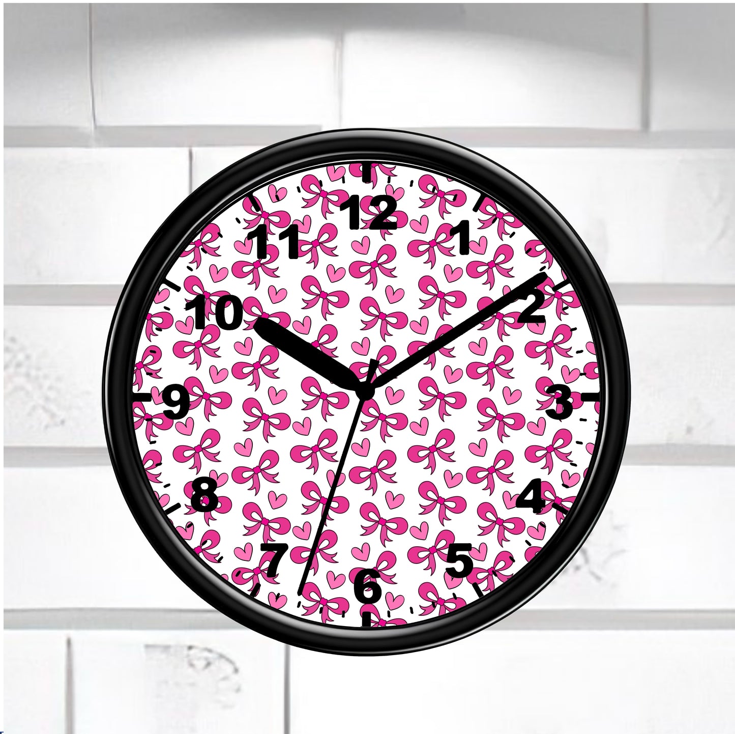 Wall clock with pink bow pattern on a white brick wall background