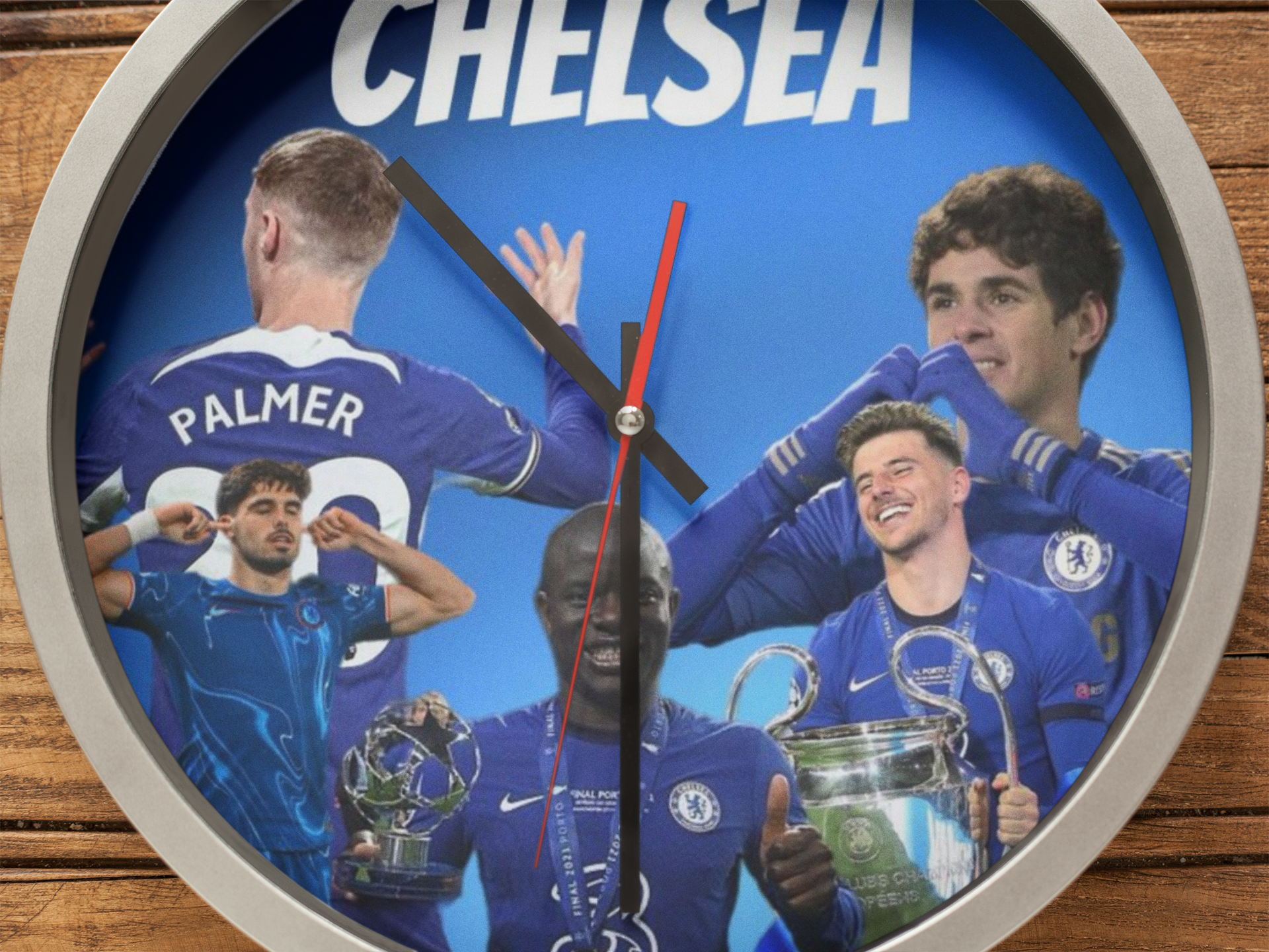 Wall clock with Chelsea players and trophies on a blue background