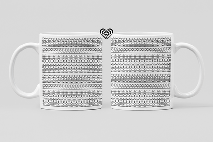 White mug with black geometric pattern on a light gray background
