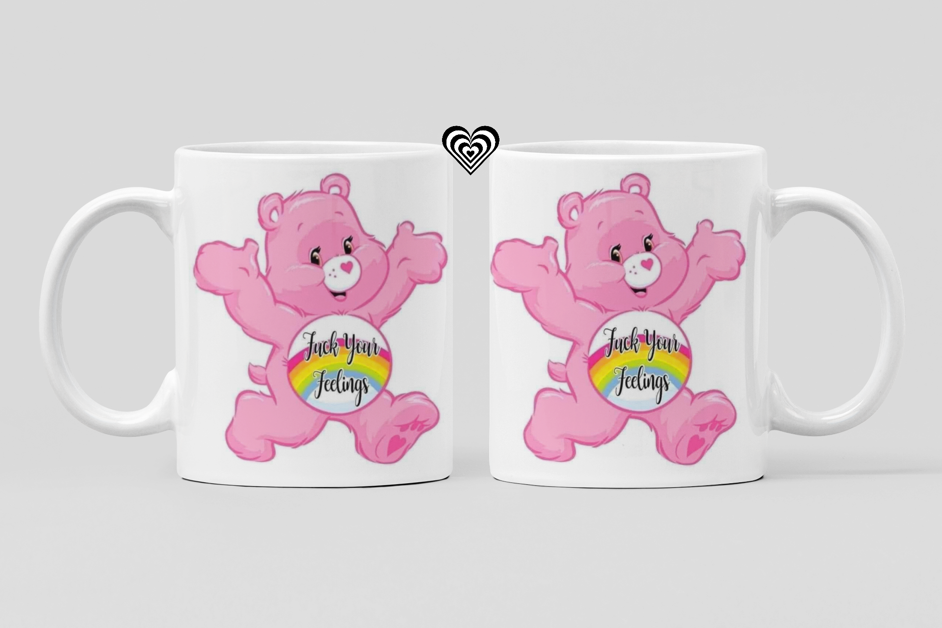 Two white mugs with pink cartoon bear characters and rainbow text "f*ck your feelings" on a light gray background.