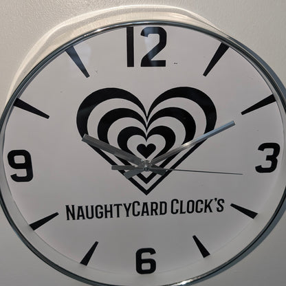 Wall clock with heart design and 'NaughtyCard Clock's' branding on a white background