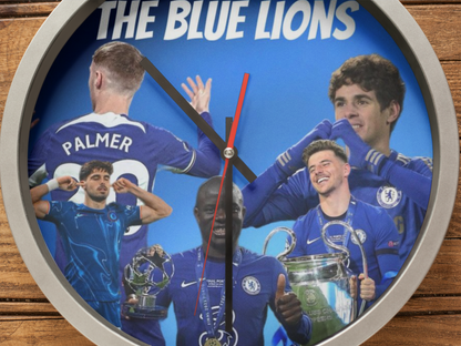 Wall clock with images of soccer players and 'The Blue Lions' text on a blue background