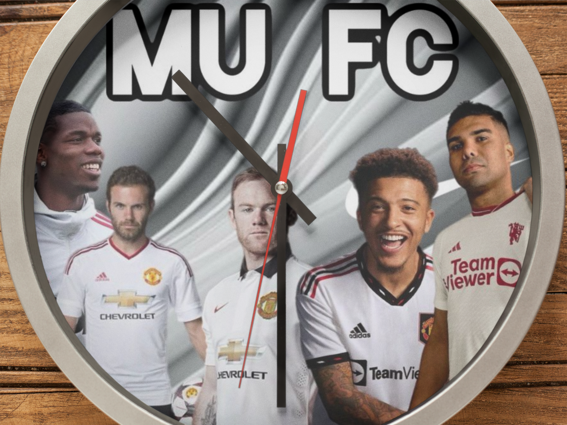 Wall clock with images of football players and 'MU FC' text on a wooden background