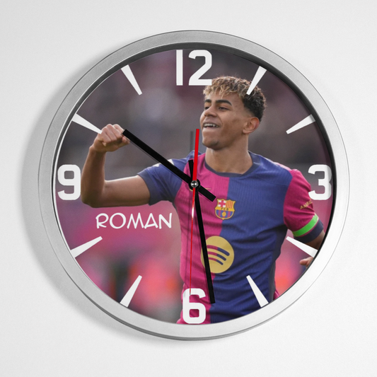 A wall clock featuring an image of Lamine Yamal with a raised fist, predominantly in colours blue and red, with clock hands and numbers.